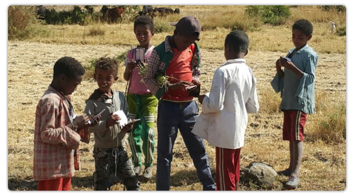 Kids reading Chick tracts in Ethiopia.